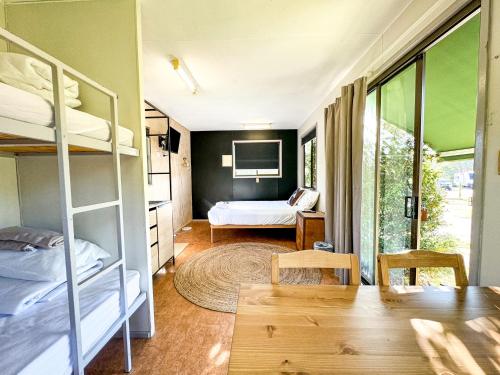 a room with bunk beds and a bedroom at Stanthorpe Holiday Park in Severnlea