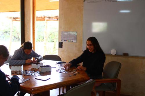 a group of people sitting around a table playing a game at Bosch Luys Kloof Nature Reserve in Ladismith