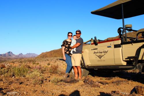 a man and woman standing in front of a vehicle at Bosch Luys Kloof Nature Reserve in Ladismith