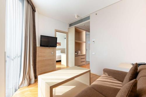 a living room with a couch and a table at Hilton Garden Inn Venice Mestre in Mestre