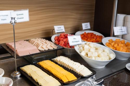 a buffet of food with cheese and other foods at Holiday Inn Guayaquil Airport by IHG in Guayaquil