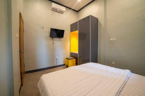 Ένα ή περισσότερα κρεβάτια σε δωμάτιο στο Asera Homestay