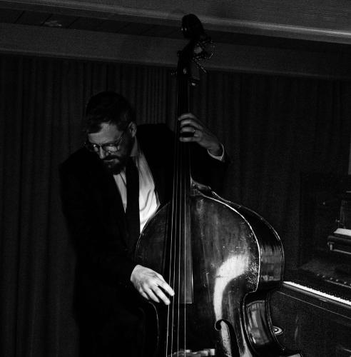 a man in a suit playing a cello at Hôtel Reisen in The Unbound Collection by Hyatt in Stockholm