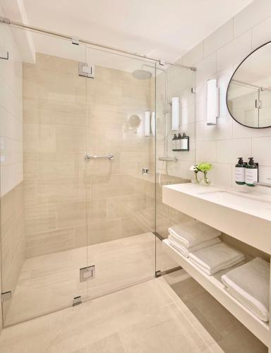 a bathroom with a glass shower and a sink at Hôtel Reisen in The Unbound Collection by Hyatt in Stockholm