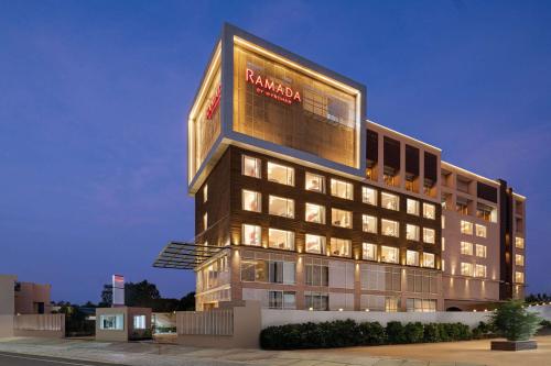 a building with a sign on the side of it at Ramada by Wyndham Gorakhpur Gorakhnath Mandir Road in Gorakhpur