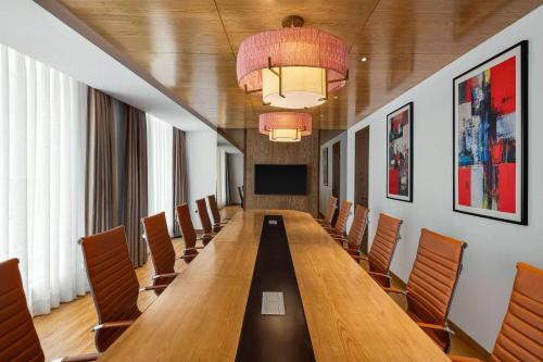 a conference room with a long table and chairs at Ramada by Wyndham Gorakhpur Gorakhnath Mandir Road in Gorakhpur