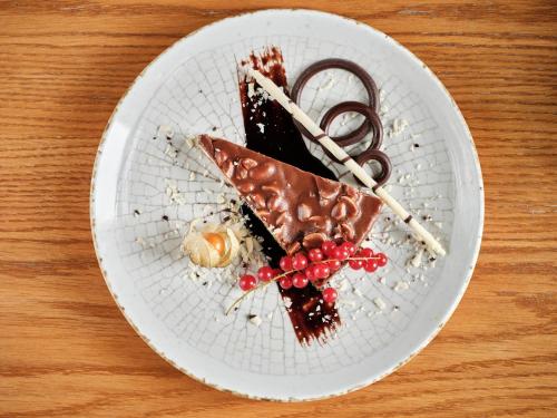 a white plate with a piece of chocolate dessert at Holiday Inn Gdansk - City Centre by IHG in Gdańsk