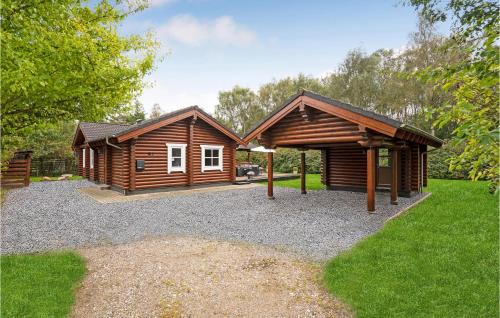 a log cabin with a pavilion in a yard at Holiday Home Ramshule Farsø Xii in Hvalpsund