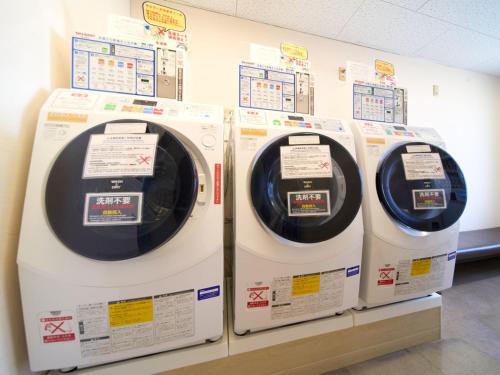three washing machines are on display in a store at Meitetsu Inn Kariya in Kariya