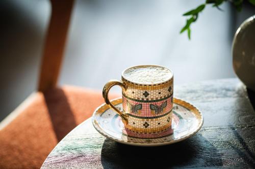 a coffee cup on a plate on a table at Kimpton Everly Hotel Hollywood by IHG in Los Angeles