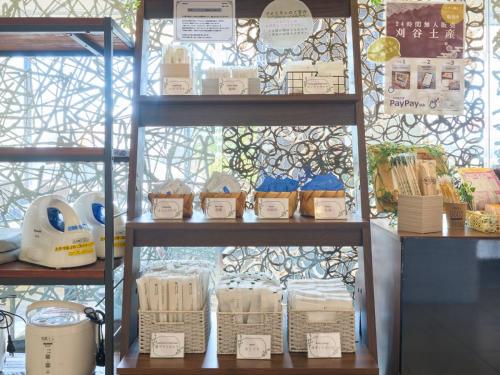 a shelf with baskets and other items in a store at Meitetsu Inn Kariya in Kariya