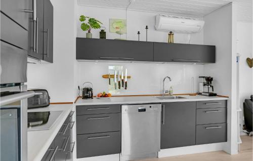 a kitchen with gray cabinets and a sink at Nice Home In Kirke Hyllinge With Wifi in Kirke-Hyllinge