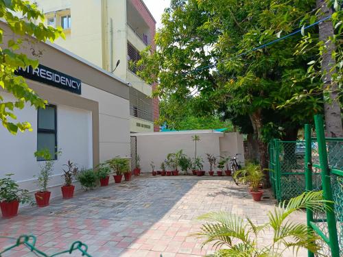 a building with a lot of potted plants in front of it at SM Residency in Bhubaneshwar