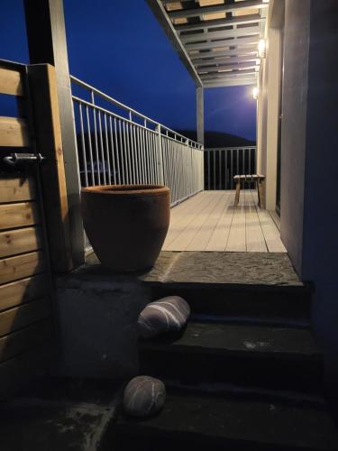 a balcony with a large bowl on the side of a building at The Boat House in Adrigole