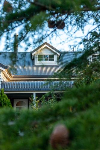 a house with a tin roof and a window at The Ranch-pool Table, Table Tennis, Firepit, Piano in Stanthorpe