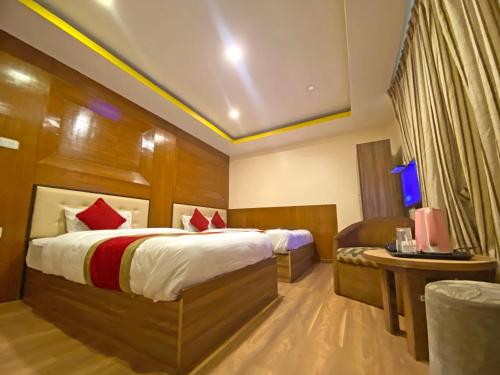 a hotel room with a bed and a table at Hotel Airport Holiday in Kathmandu