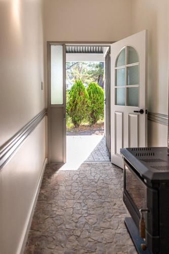 an open door in a room with a hallway at The Ranch-pool Table, Table Tennis, Firepit, Piano in Stanthorpe