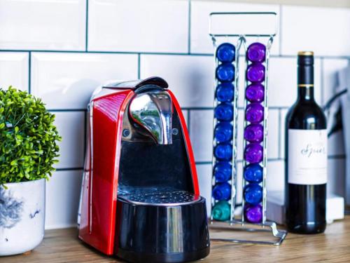 a toaster sitting on a counter next to bottles of wine at The Den On Plover in Velddrif