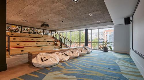 a room with a row of bean bags on the floor at voco Leicester by IHG in Leicester