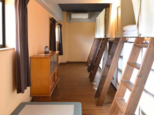 a group of bunk beds in a room at ゲストハウス星風 in Suo Oshima
