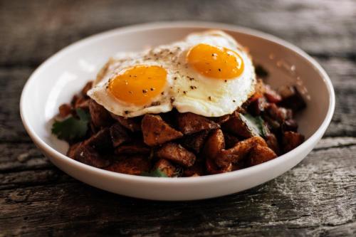 a bowl of breakfast food with eggs on top at Crowne Plaza - Chicago West Loop by IHG in Chicago