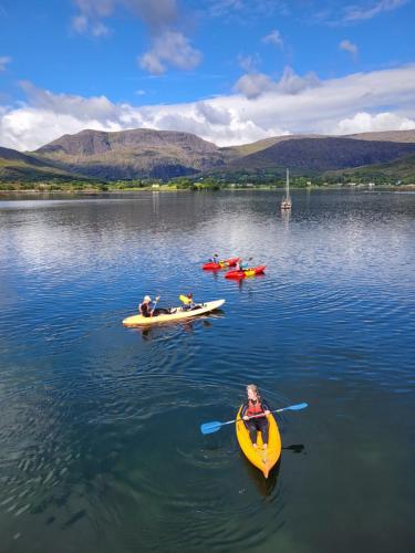 a group of people in kayaks on a lake at The Boat House in Adrigole