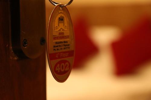 a close up of a door tag on a door knob at Hotel Airport Holiday in Kathmandu