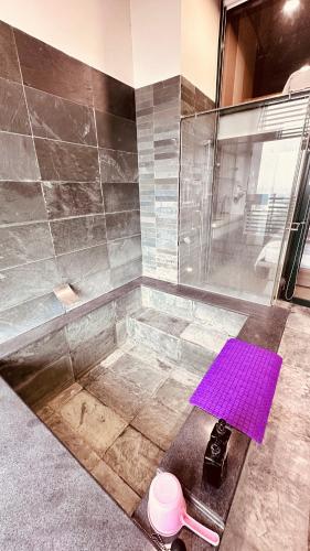 a bathroom with a shower with a purple floor at 天天泡湯 in Yilan City