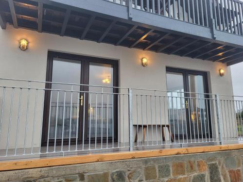 a balcony of a house with a railing at The Boat House in Adrigole