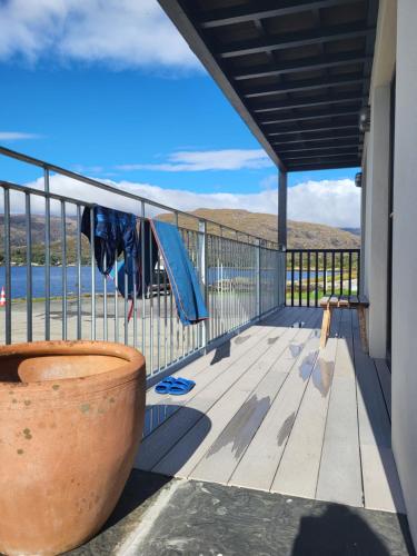 a balcony with a view of the water at The Boat House in Adrigole