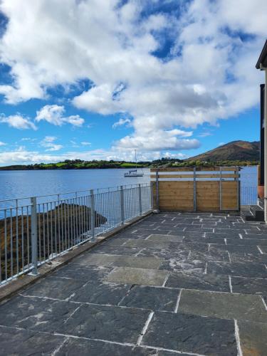 a view of a body of water with a fence at The Boat House in Adrigole