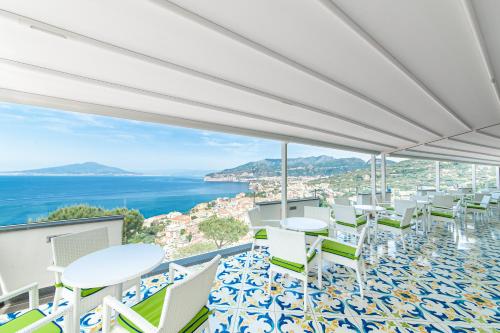 a view from the balcony of a hotel with tables and chairs at Grand Hotel President in Sorrento