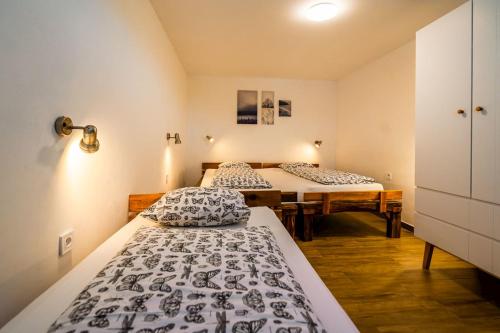 two beds in a small room at Hacienda Napoli in Sebechleby