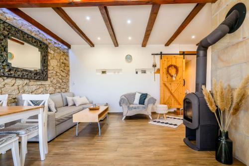 a living room with a wood stove at Hacienda Napoli in Sebechleby