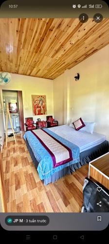 a bedroom with two beds and a wooden ceiling at Moc's House bắc hà in Bắc Hà