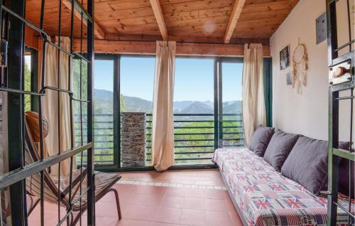 a living room with a couch and a large window at Awesome Apartment In Casarza Ligure in Casarza Ligure