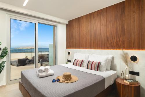 a bedroom with a bed with hats and towels on it at Elia Sea Suites in Chania Town