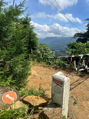 a stone box sitting on the side of a hill at 4154ft in ramboda in Ramboda