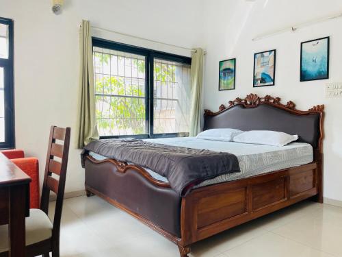 a bedroom with a large bed and a window at Lifespace- Spacious Hostel in a Luxurious Villa in Pune