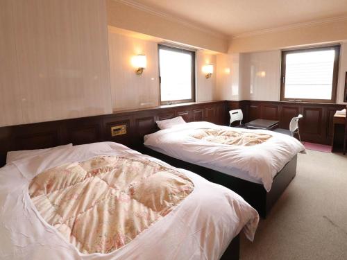 Postel nebo postele na pokoji v ubytování Hotel Wakamizu