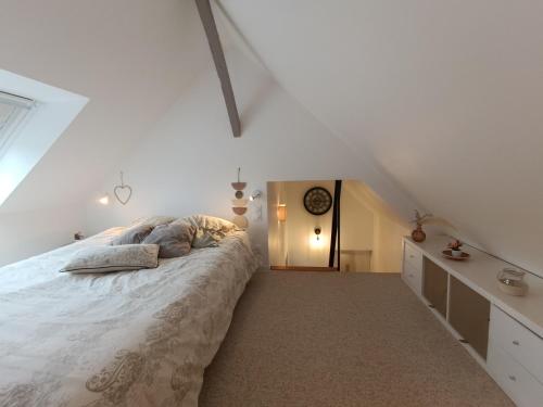 a bedroom with a large bed in a attic at Un Appart' à la campagne in Mordelles