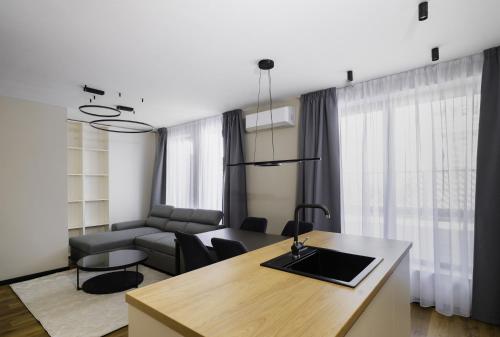 a kitchen and living room with a table and a couch at Aviva Living by Flat Mаnager in Sofia
