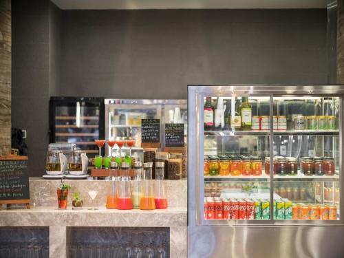 a counter with a refrigerator filled with lots of drinks at Dongguan Marriott Hotel in Dongguan