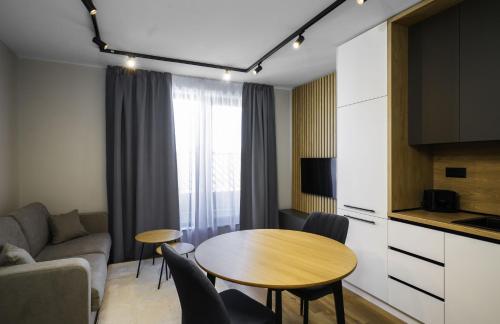 a living room with a table and a couch at Aviva Living by Flat Mаnager in Sofia