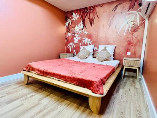a bedroom with a bed with a red bedspread at Joyau caché en plein cœur de Martigues ! in Martigues