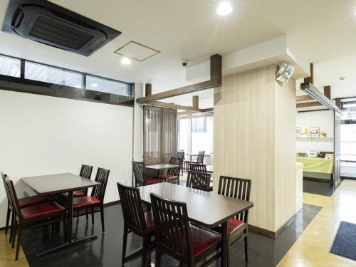 a dining room with tables and chairs at Hotel Wing International Miyakonojo in Miyakonozyō