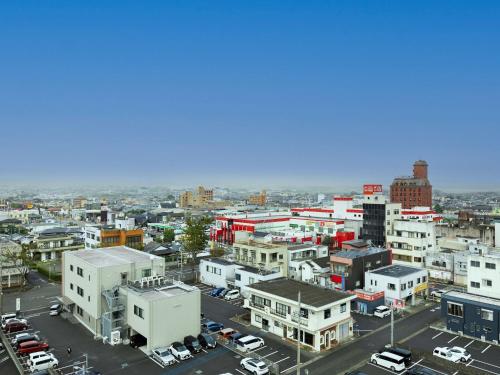 an aerial view of a city with buildings at Hotel Wing International Miyakonojo in Miyakonozyō