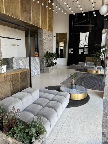 a lobby with a large couch and a table at Modern Vero Apartments Portova in Gdynia