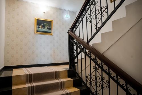 a stairway with a picture on the wall at Hotel Royal Plaza By TimHotels in Timişoara