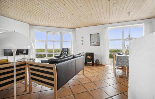 a living room with a couch and a table at 4 Bedroom Stunning Home In Thisted in Thisted